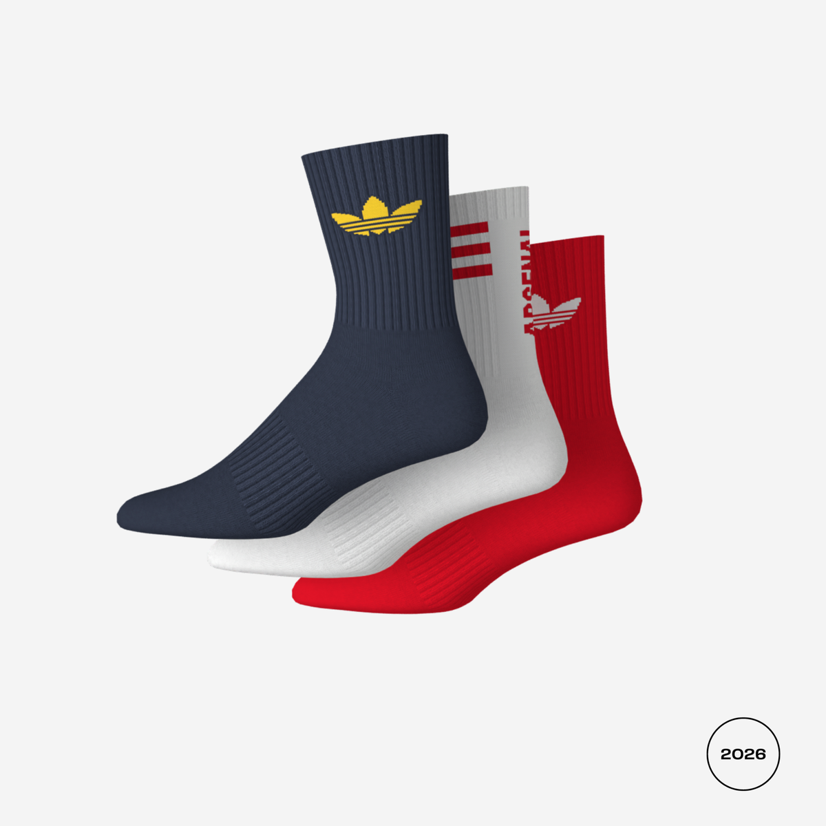 Three Adidas crew socks in navy, white, and red, arranged in a fan shape on a light gray background. The navy sock features a gold trefoil logo, the white sock has red stripes and a white trefoil logo, and the red sock has a red trefoil logo.