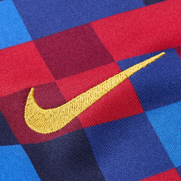 Close-up of a Nike logo on a red, blue, and yellow checkered fabric