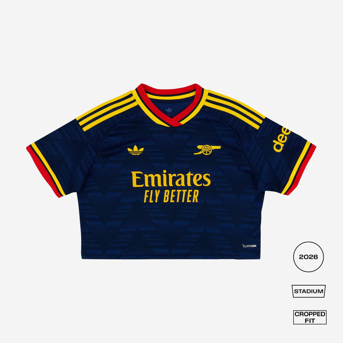 A cropped Adidas Arsenal football jersey in navy blue with yellow and red accents, featuring the Emirates Fly Better sponsor logo, Adidas logo, and Arsenal crest. The image is presented on a light gray background with fit/style labels on the bottom right.
