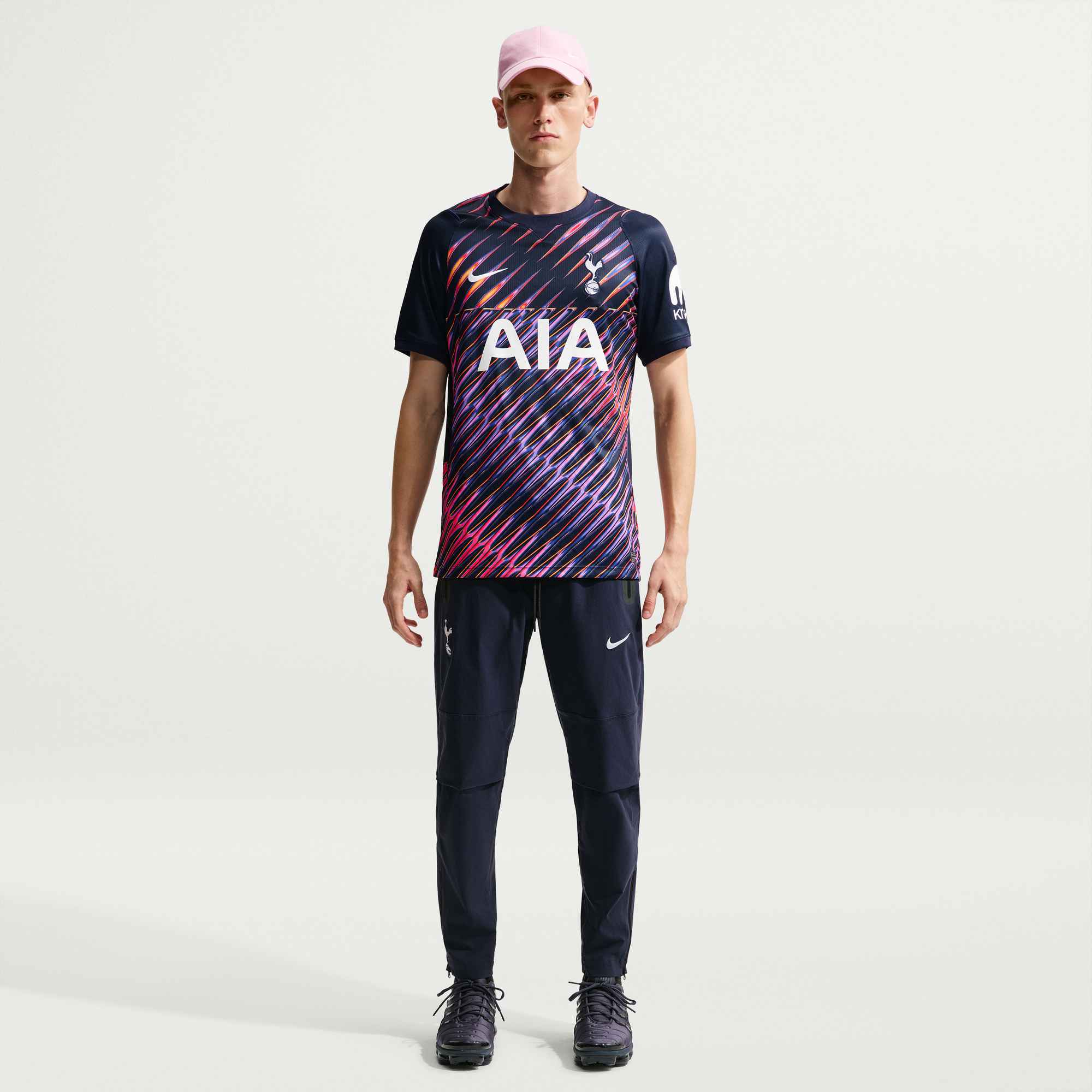 Person wearing a sports outfit with a visible brand logo on a white background