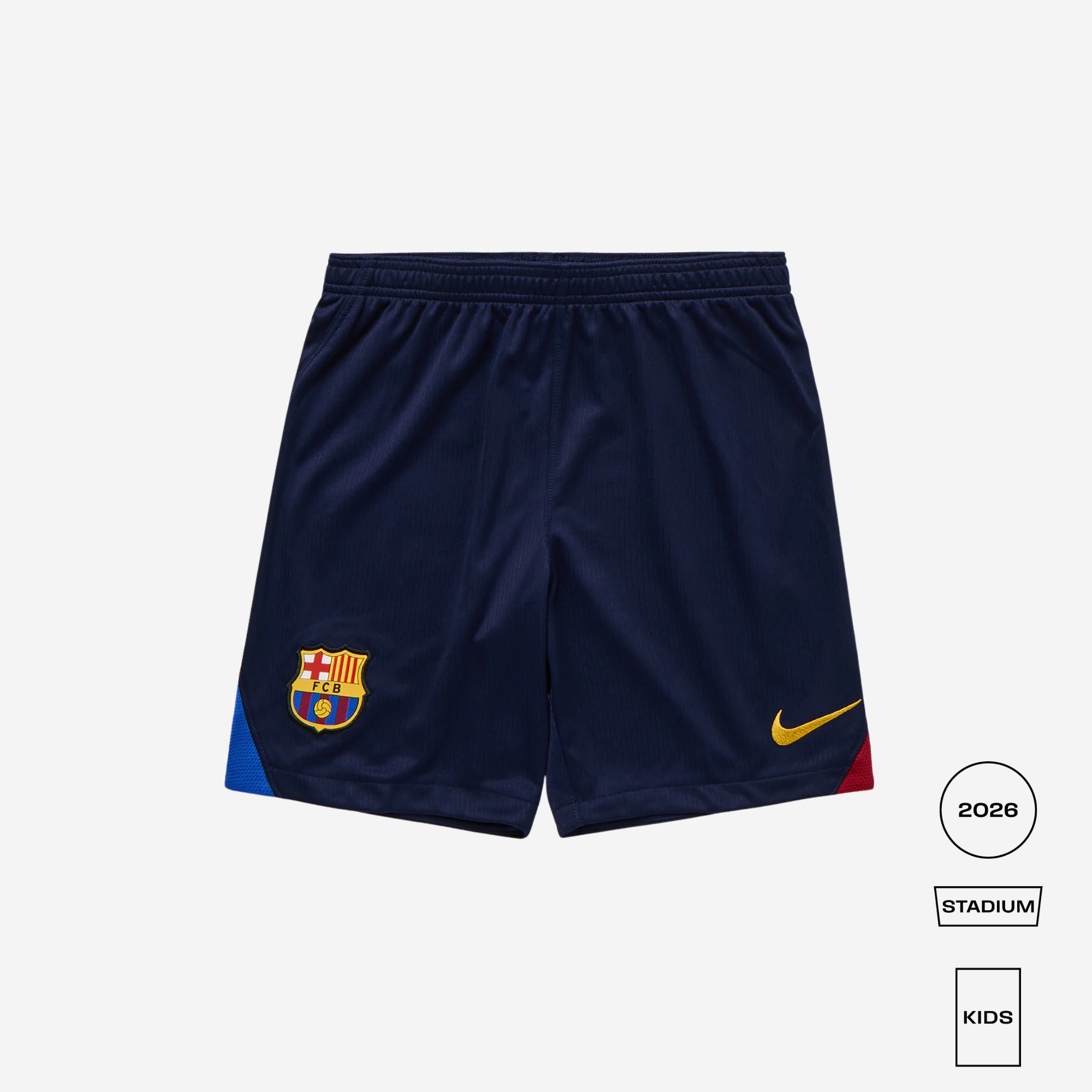 A pair of navy blue Nike FC Barcelona home soccer shorts, featuring the club crest on the left leg and a yellow Nike swoosh on the right leg, displayed against a light gray background with product details on the bottom right.