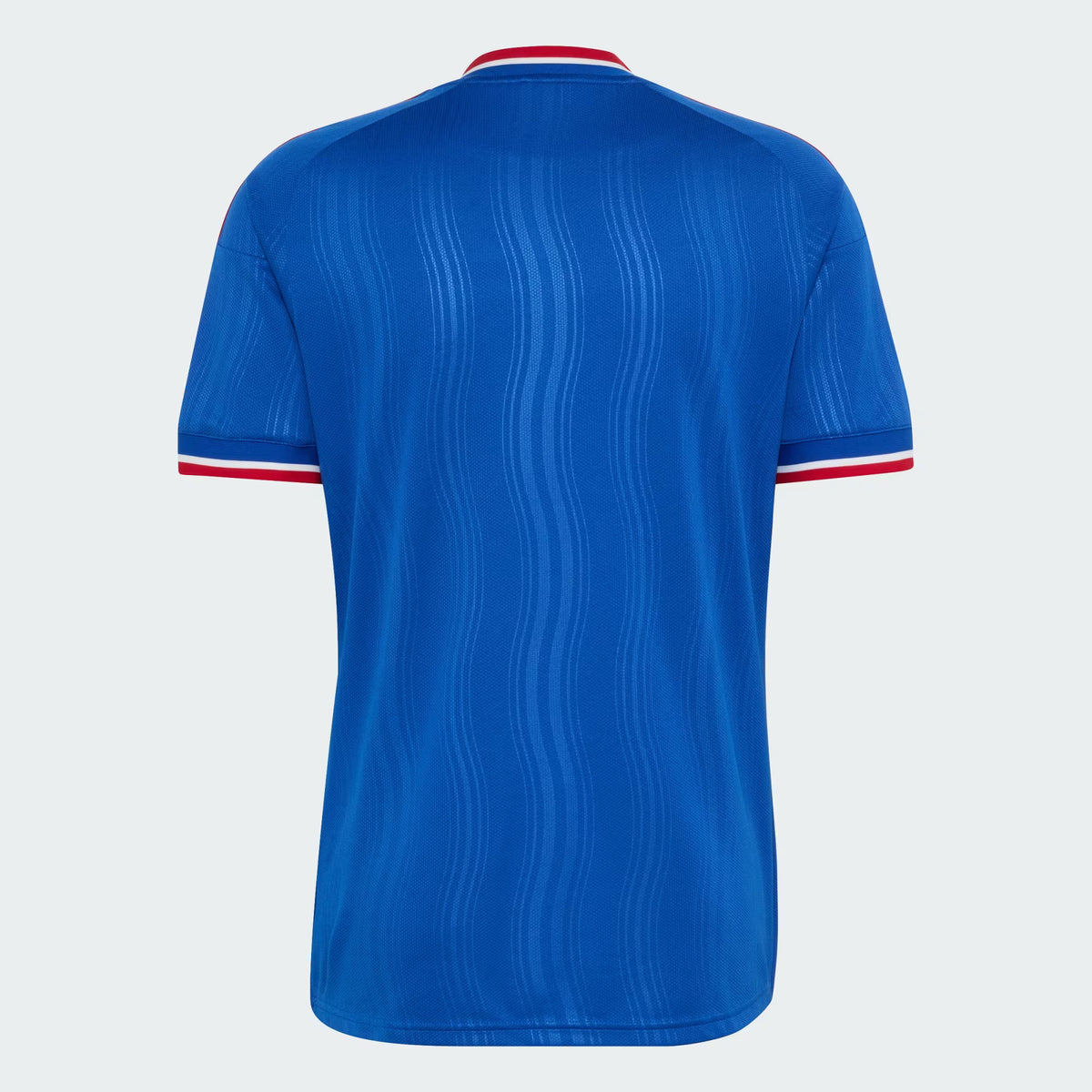 A royal blue short-sleeve soccer jersey shown from the back, featuring a subtle vertical wavy texture and red and white trim at the collar and sleeve cuffs, set against a light gray background.