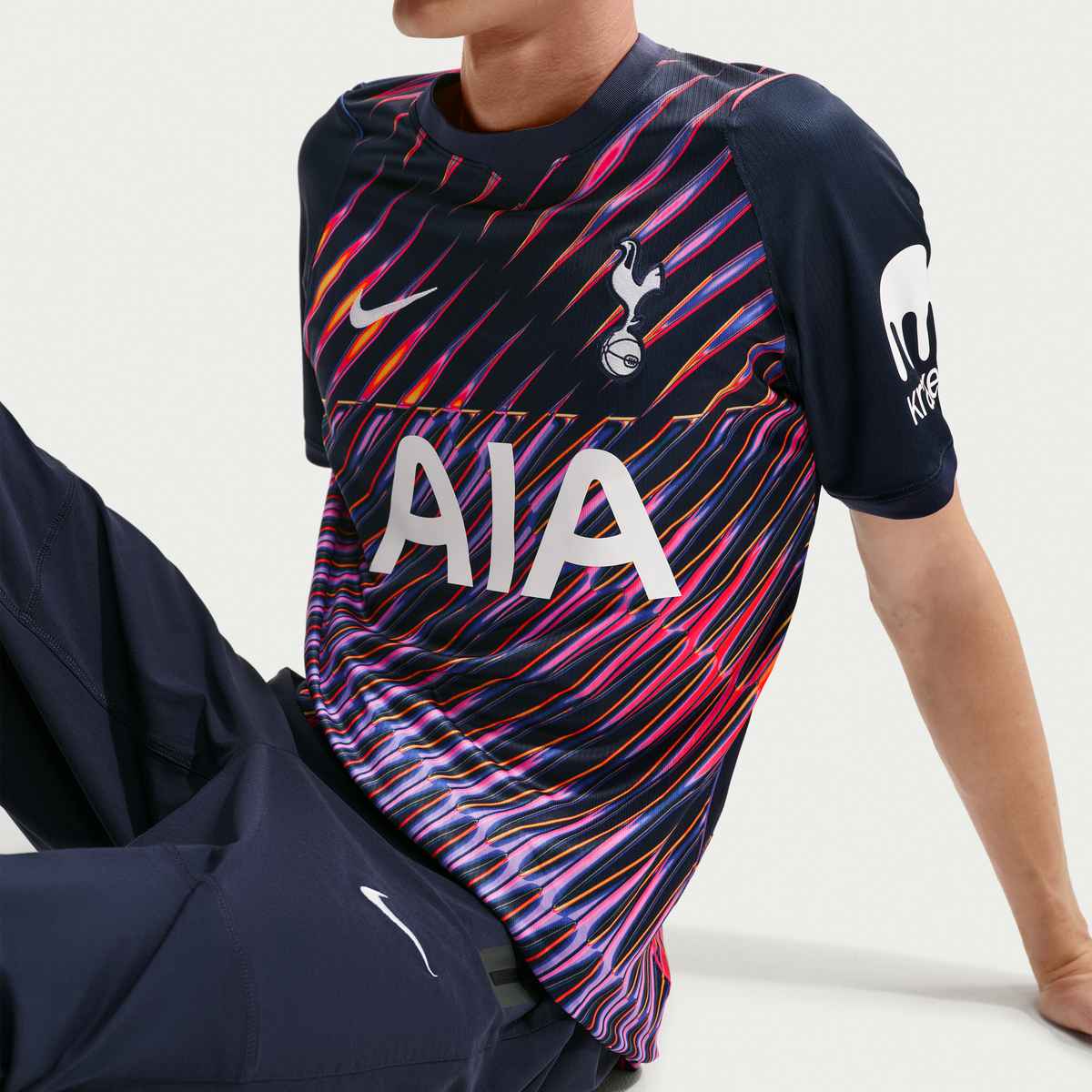 Navy sports jersey with colorful pattern and visible branding on a plain background