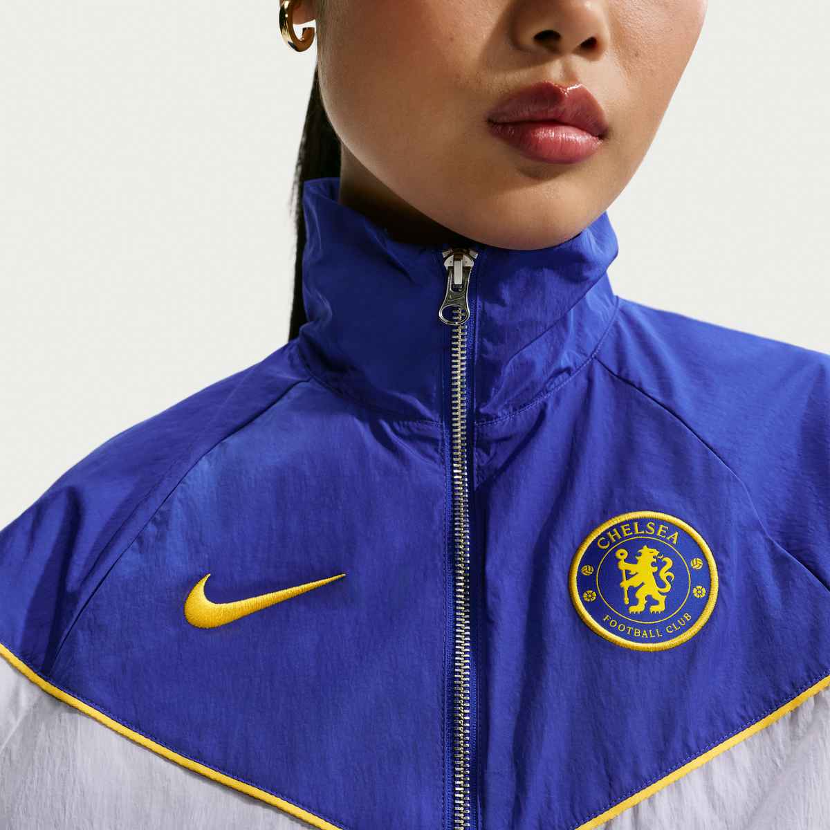 Person wearing a blue Chelsea FC jacket with Nike logo